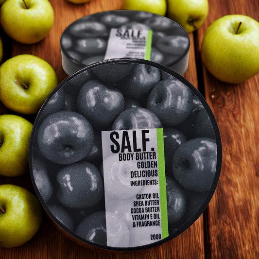 Body butter container labeled 'SALF' golden delicious body butter with green apples on a wooden surface