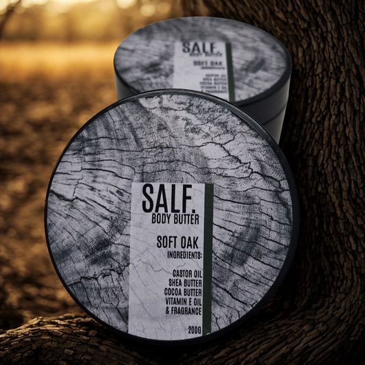 Containers of Salf Body Butter labeled 'Soft Oak' on a wooden surface.