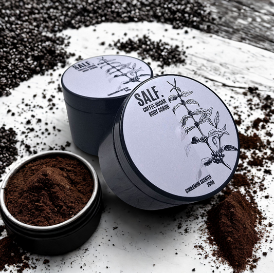 Coffee sugar body scrub with open container and ground coffee on a wooden surface